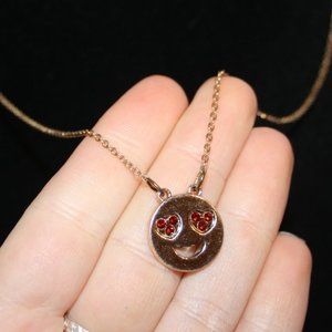 Cute gold smiley face necklace with ruby red rhinestone eyes 16-19"